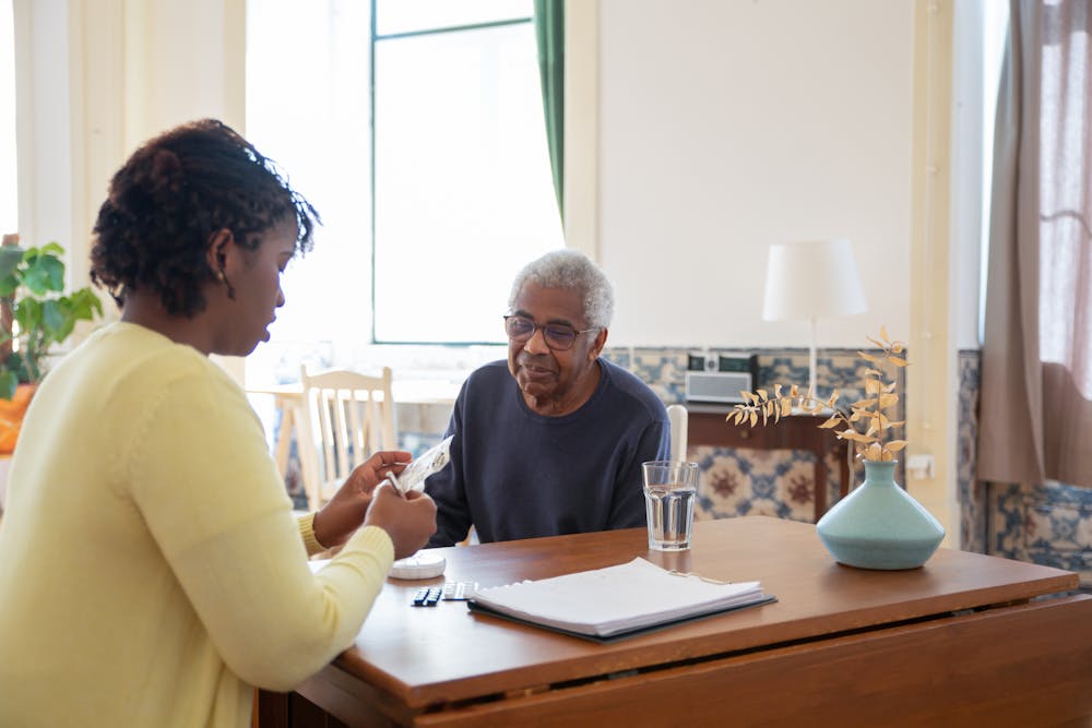 Caregiver helping an elderly person walk at home — a qualifying home care medical expense