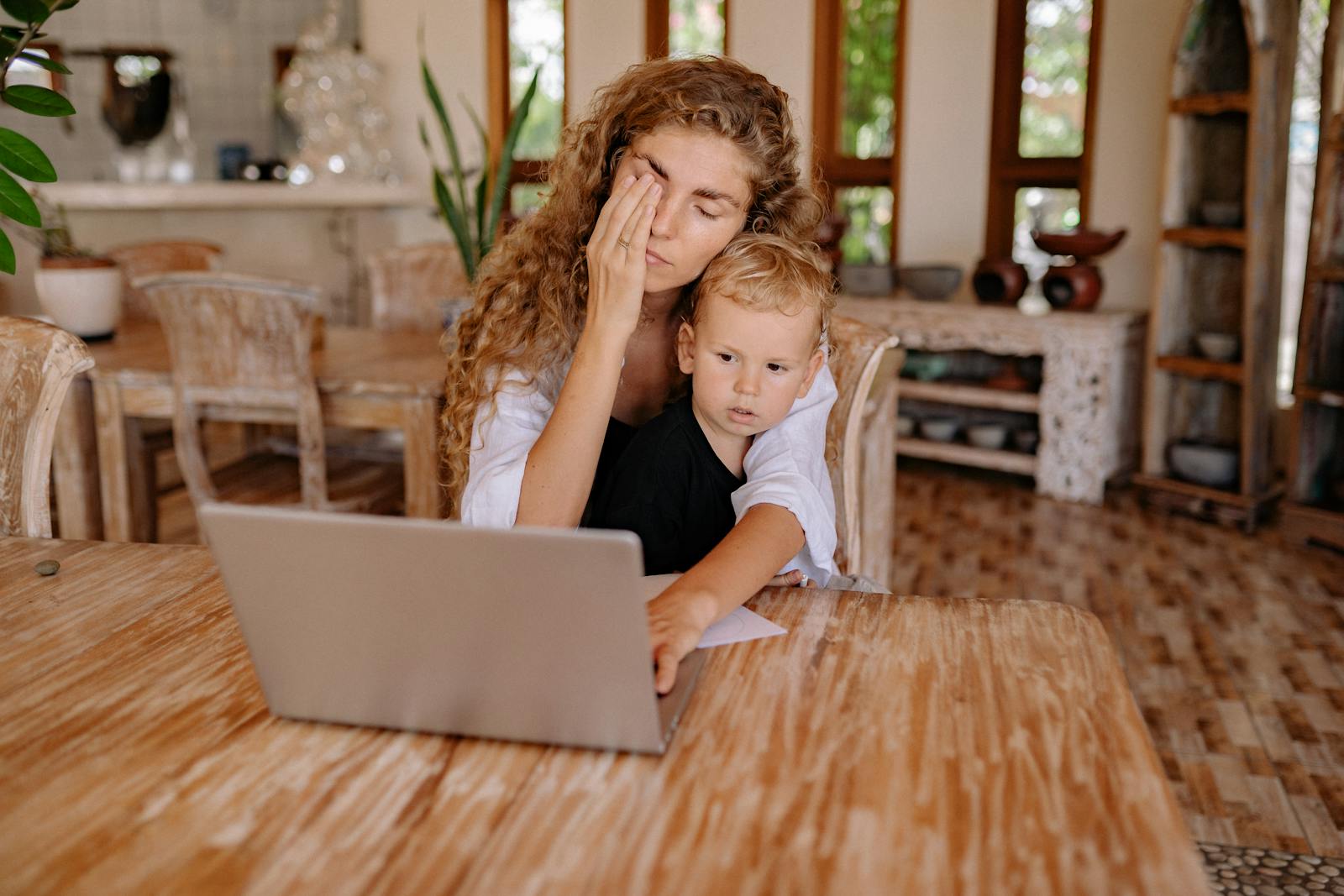 Caregiver working remotely while balancing caregiving tasks in Orange County home