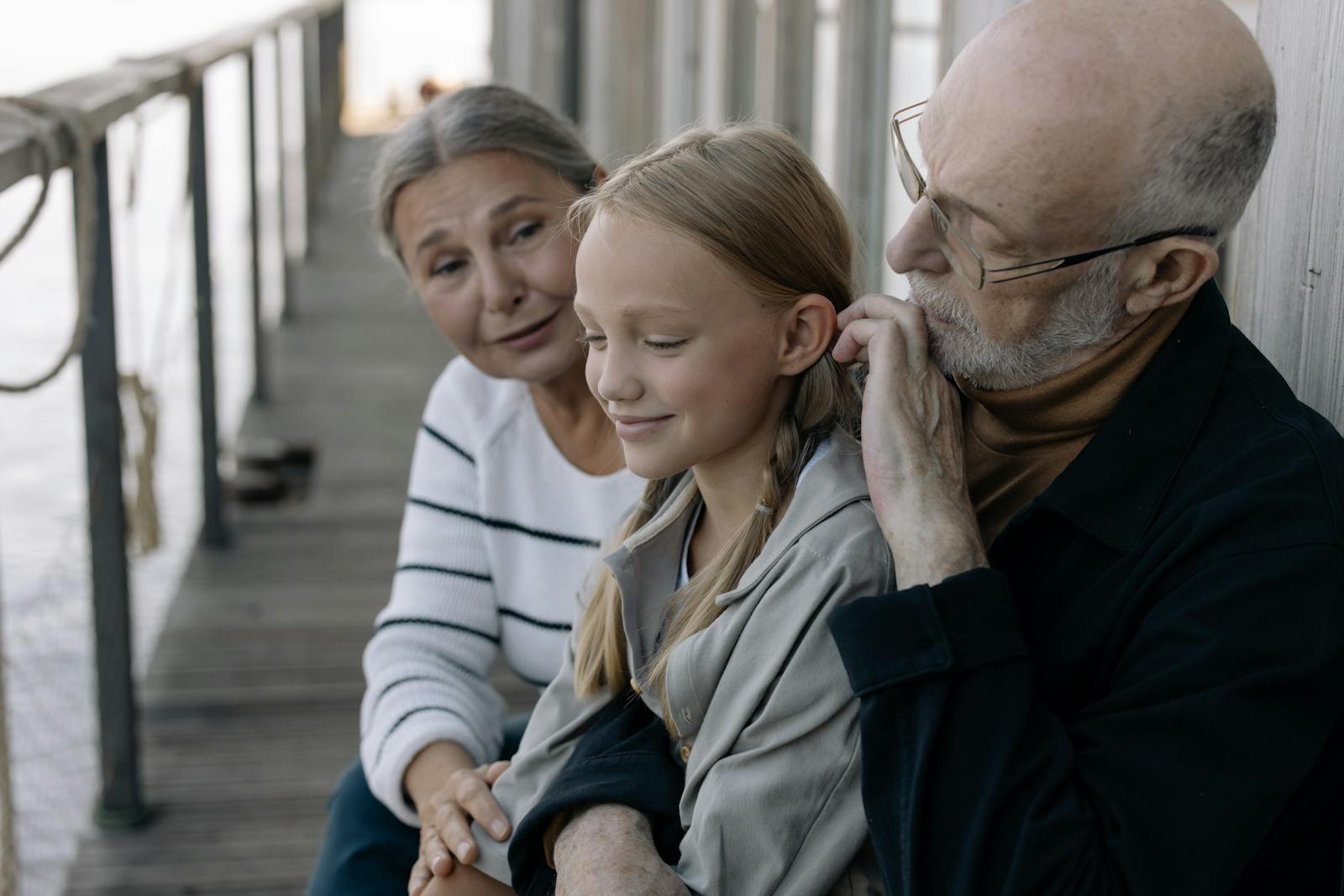 Grandparents spending time with granddaughter on deck in Orange County home