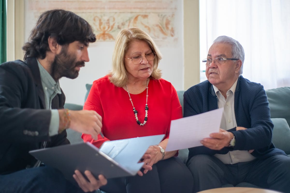 Senior couple meeting with a benefits advisor in their Orange County living room
