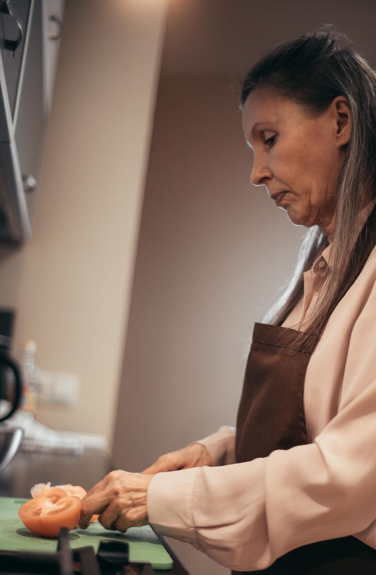 Orange County senior preparing meal at home with independent living supported by integrated plan benefits