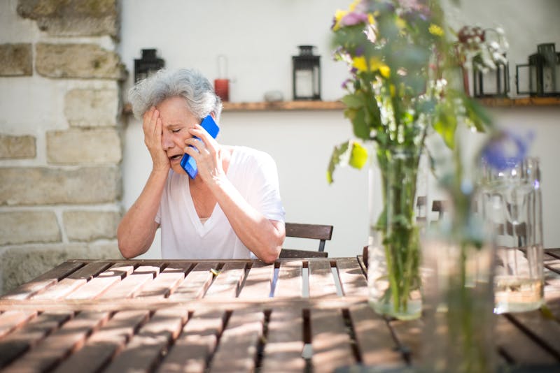 Elderly woman distressed while on a phone call