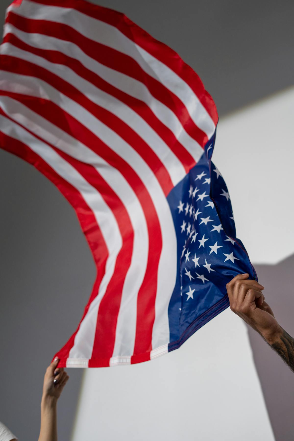 Hands holding an American flag — representing the honor and benefit veterans have earned