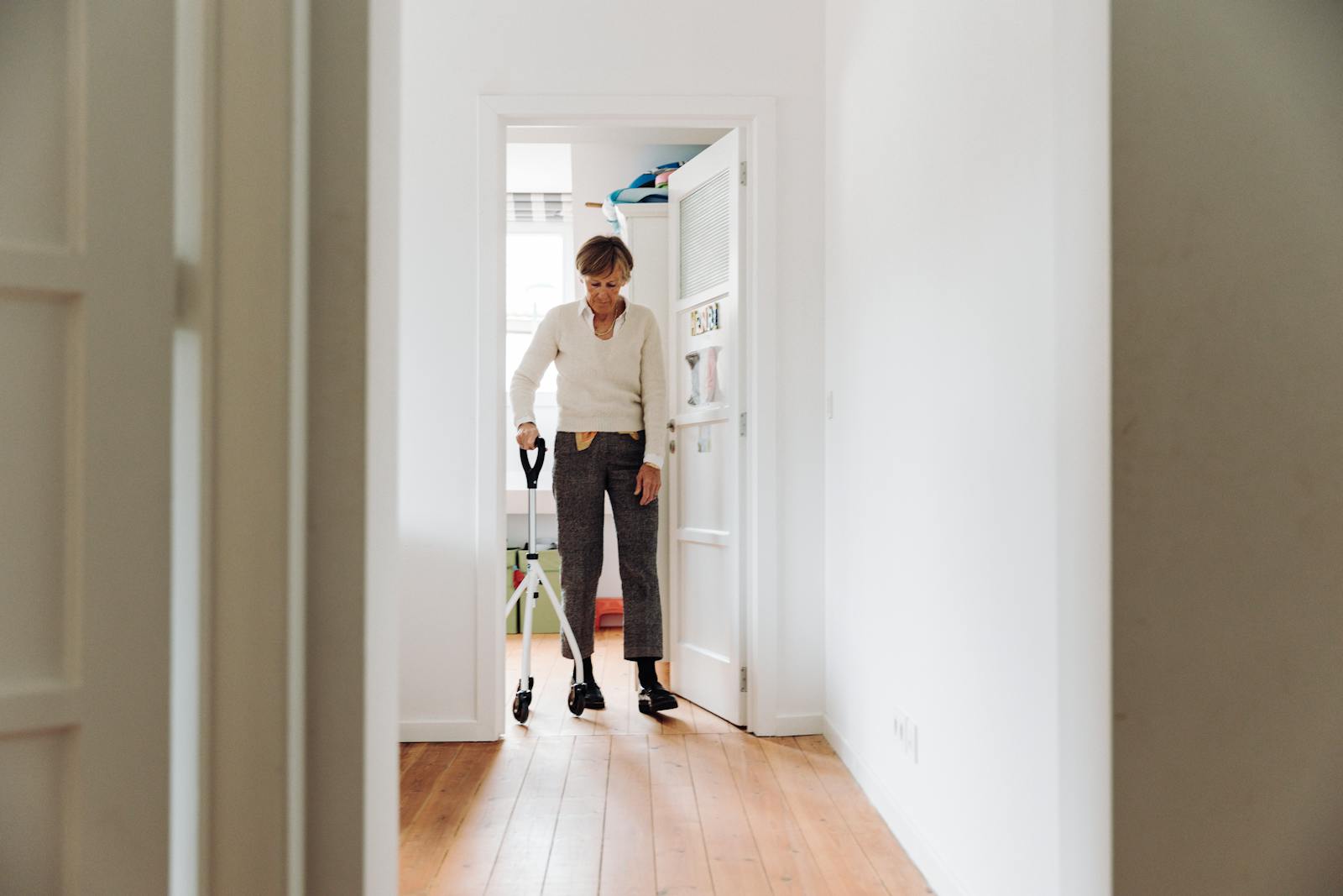 Elderly man doing arm rehabilitation exercises with caregiver at home — post-stroke recovery support