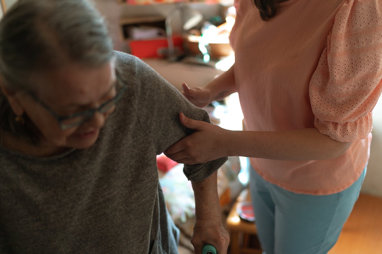 Compassionate caregiver providing home care assistance to elderly woman