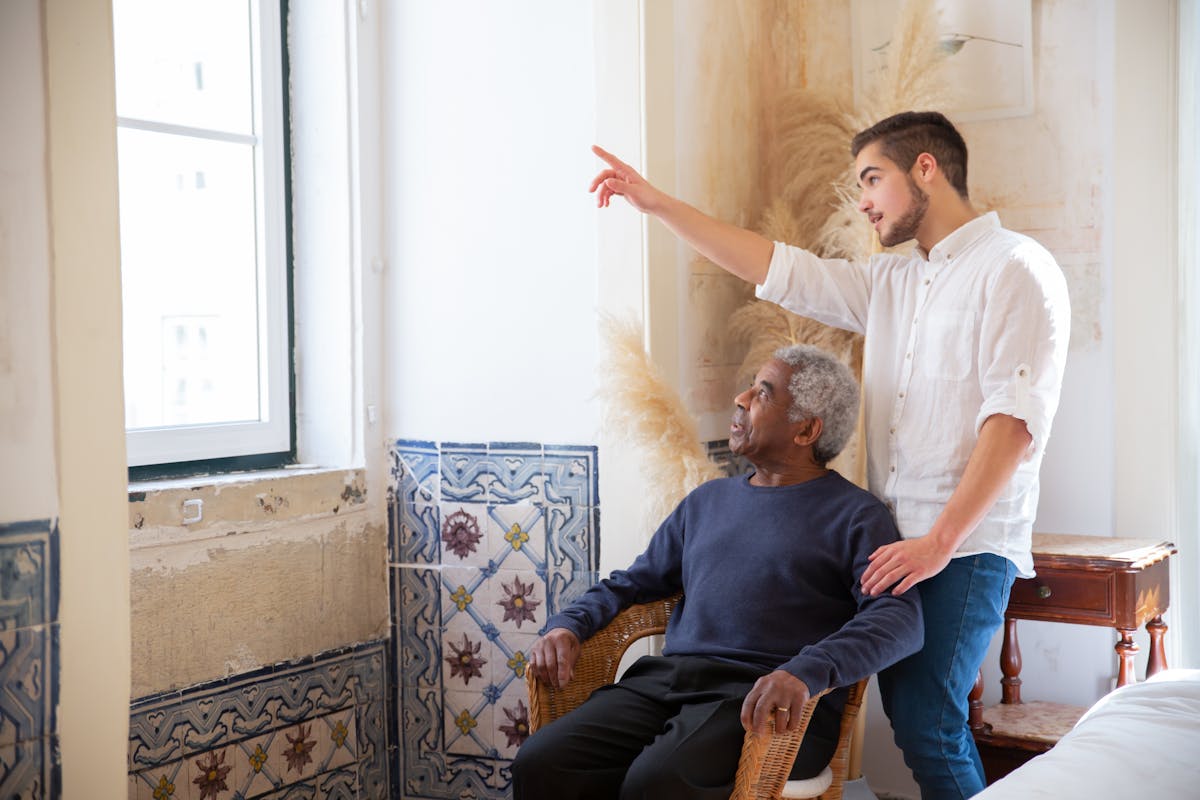 Adult child family caregiver helping elderly father with Medi-Cal documents at home
