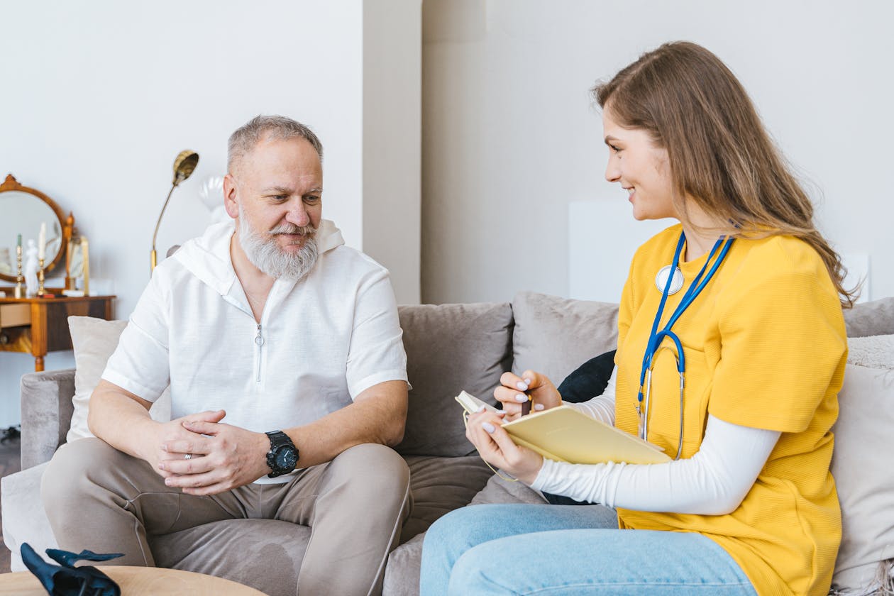 Healthcare professional consulting with elderly man in Orange County - Alzheimer's home care support