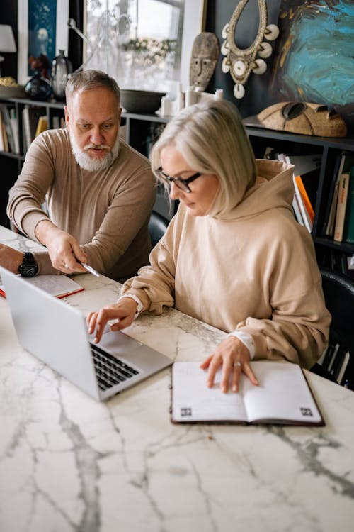 OC senior couple reviewing Medi-Cal renewal requirements and asset documentation online at home in 2026