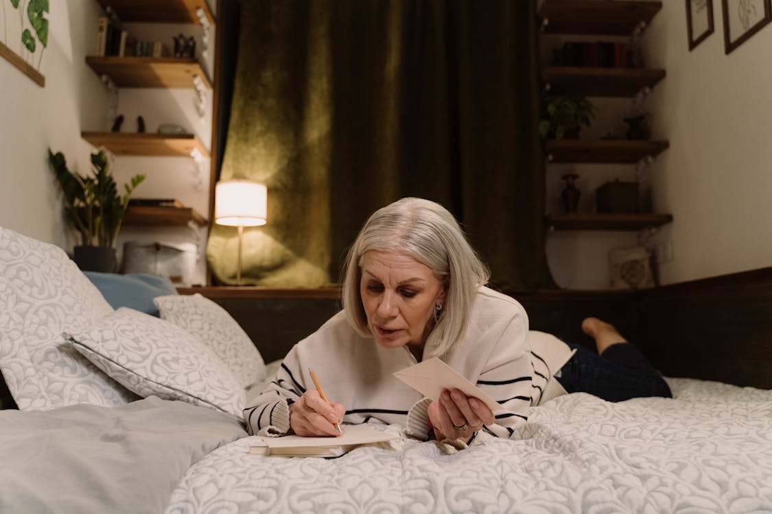 Senior Orange County woman carefully reviewing her official Medi-Cal renewal documents at home