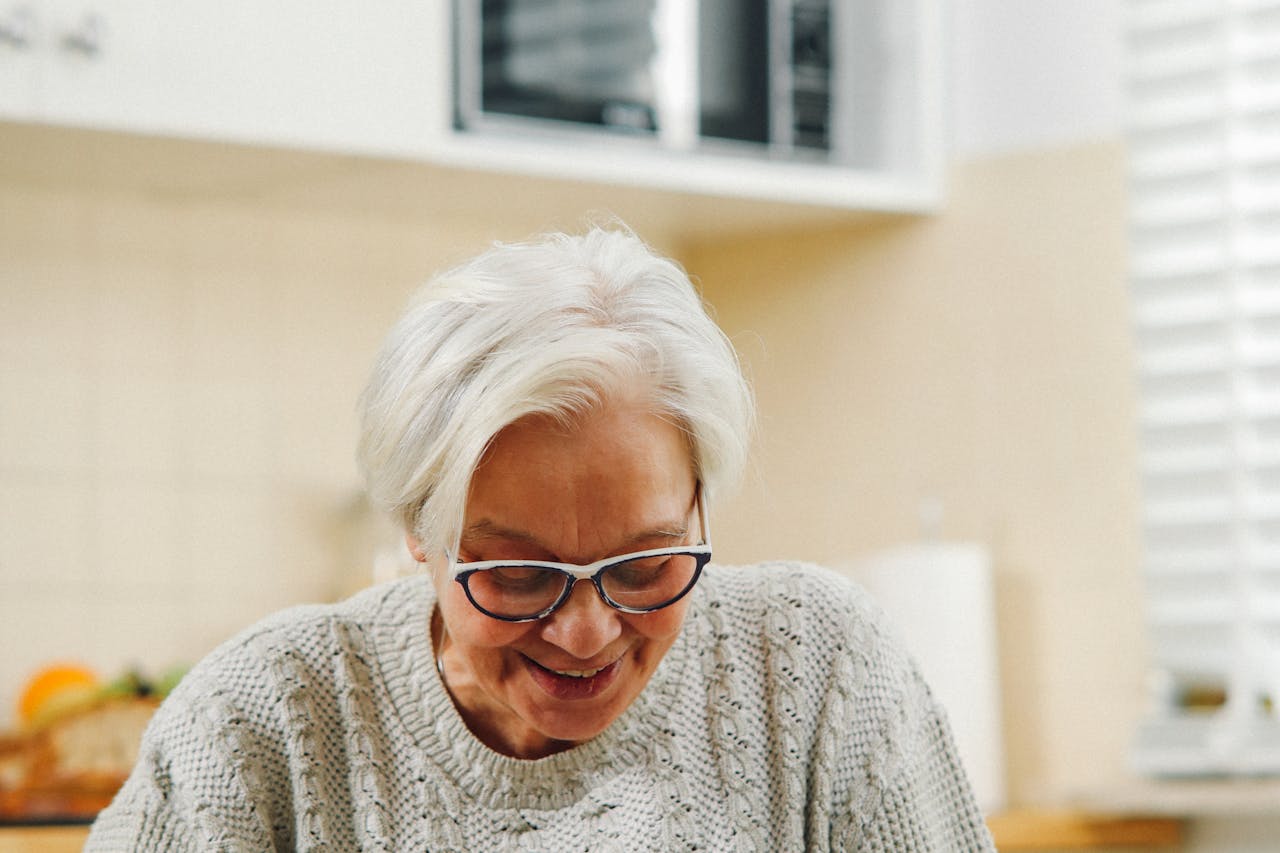 Senior Orange County woman planning Medi-Cal application paperwork in advance at her kitchen table