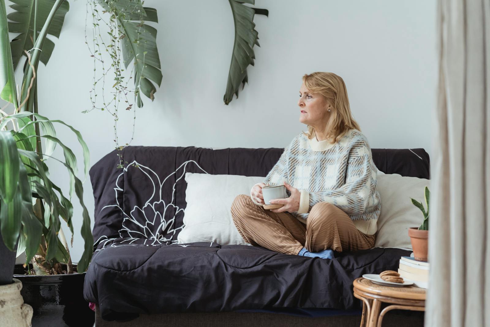 Middle-aged caregiver enjoying a peaceful coffee break - Mother's Day respite for adult daughters
