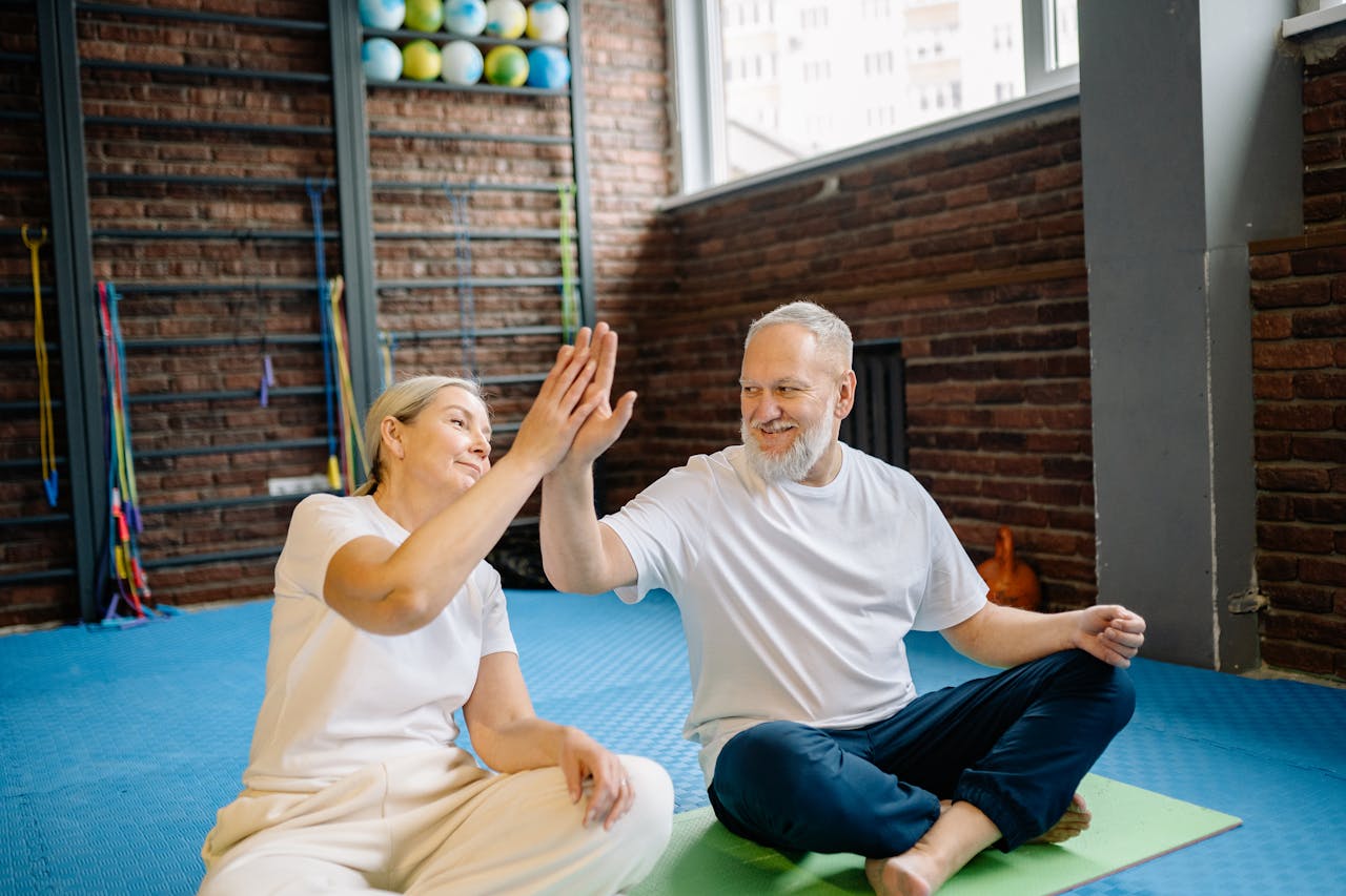 Two older adults celebrating during a strength training session