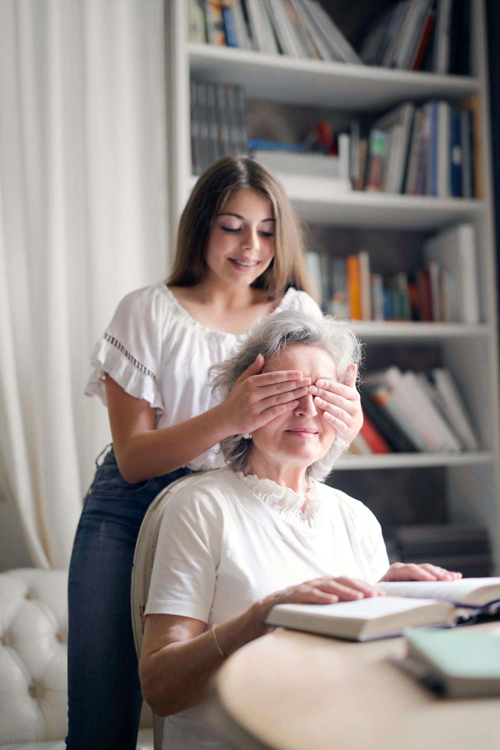 Grandmother and granddaughter playing a game together at home