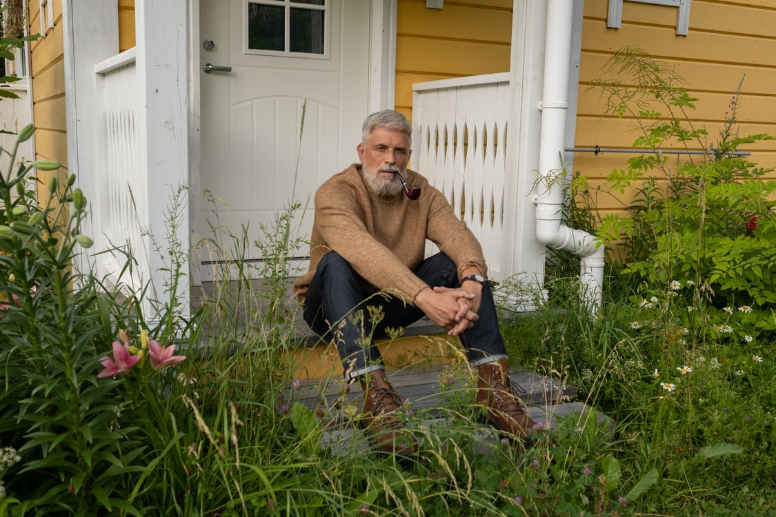 Elderly man sitting on a porch during a warm summer day in Orange County