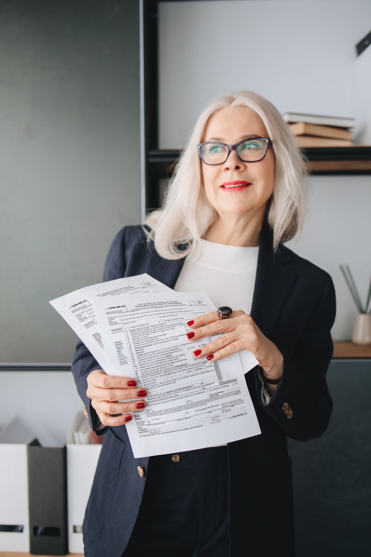 Senior woman reviewing Medicare documents — understanding GUIDE eligibility starts with knowing your loved one's living situation