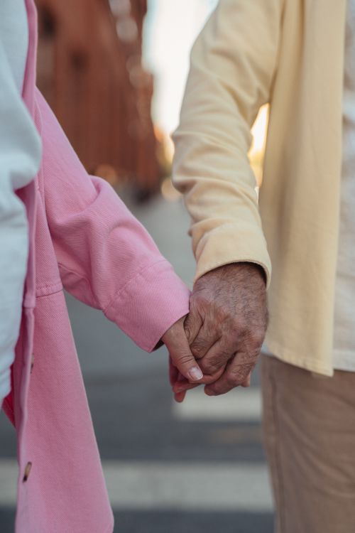 Elderly couple holding hands — vulnerable seniors who depend on IHSS backup care in Orange County