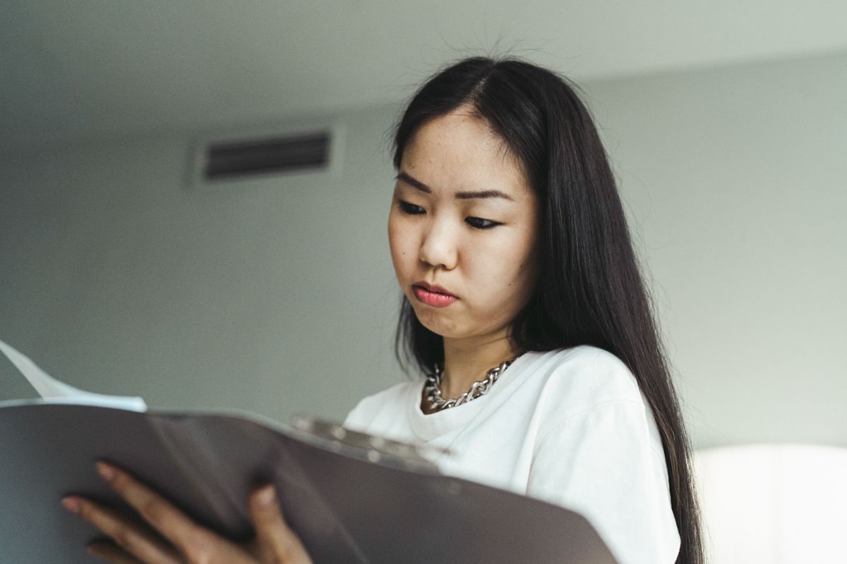 Adult daughter reviewing CalAIM caregiver respite application for parent in Orange County