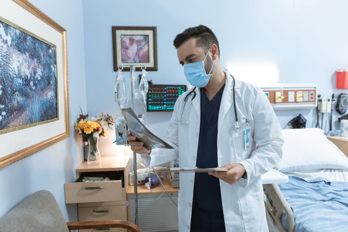 Doctor reviewing dental or medical X-ray in Orange County hospital — routine care requires action before July 1 deadline