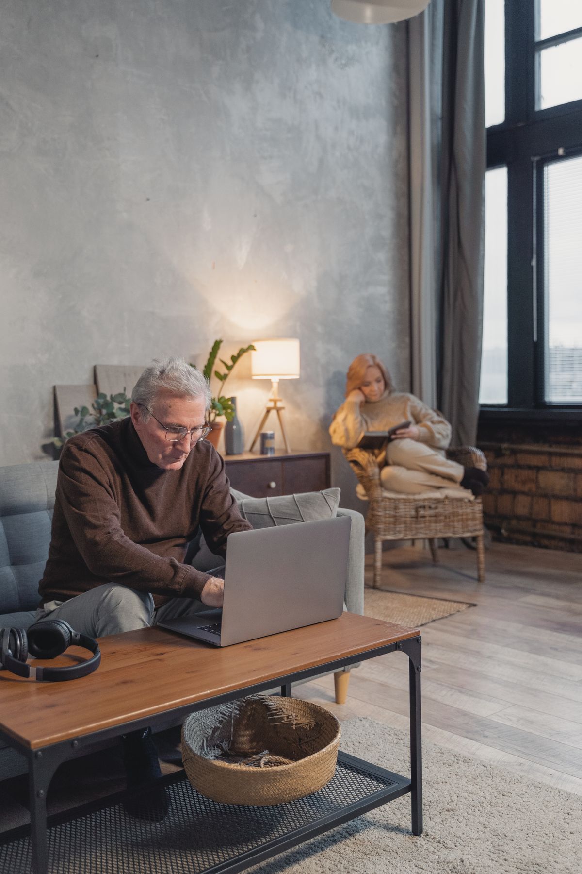 Older adults relaxing comfortably indoors in a cool, air-conditioned living room during an OC heat advisory
