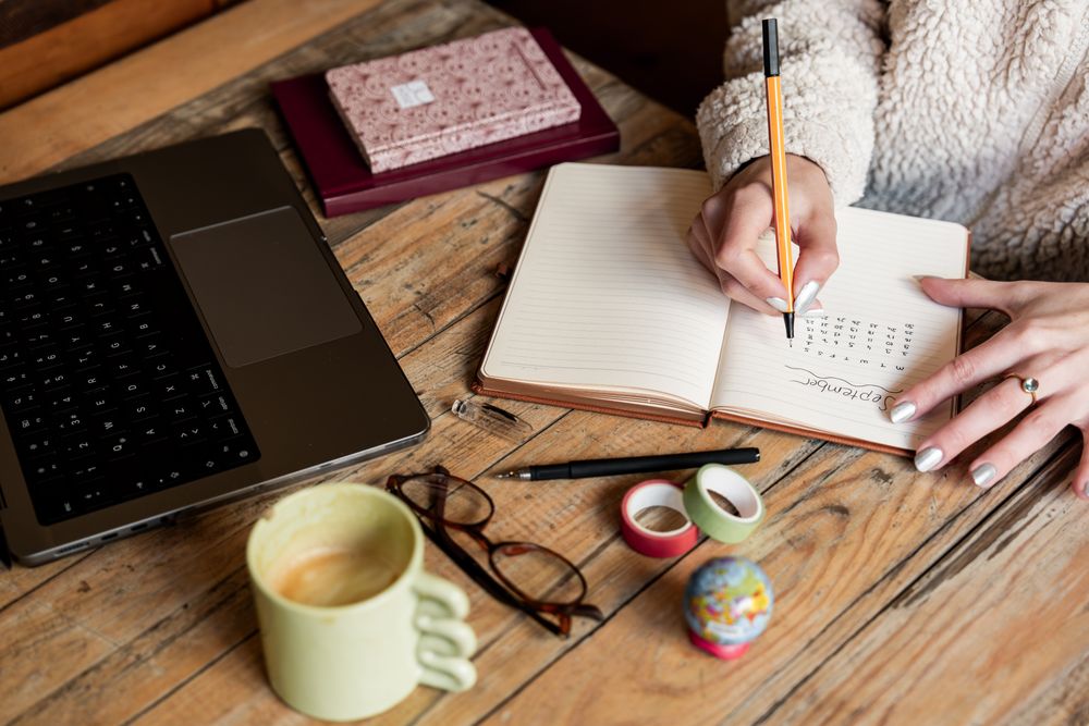 Orange County family caregiver writing a care plan and travel checklist before a summer trip