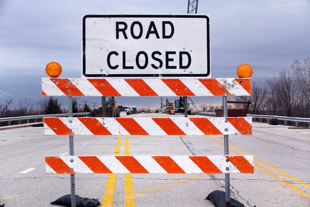 A ROAD CLOSED barrier sign blocking a street