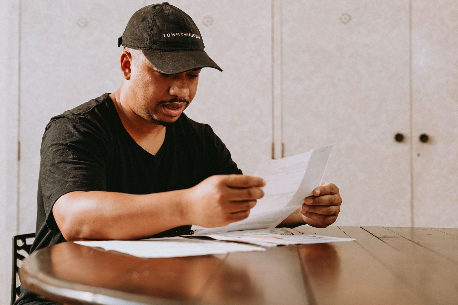 Man reviewing documents at a table at home