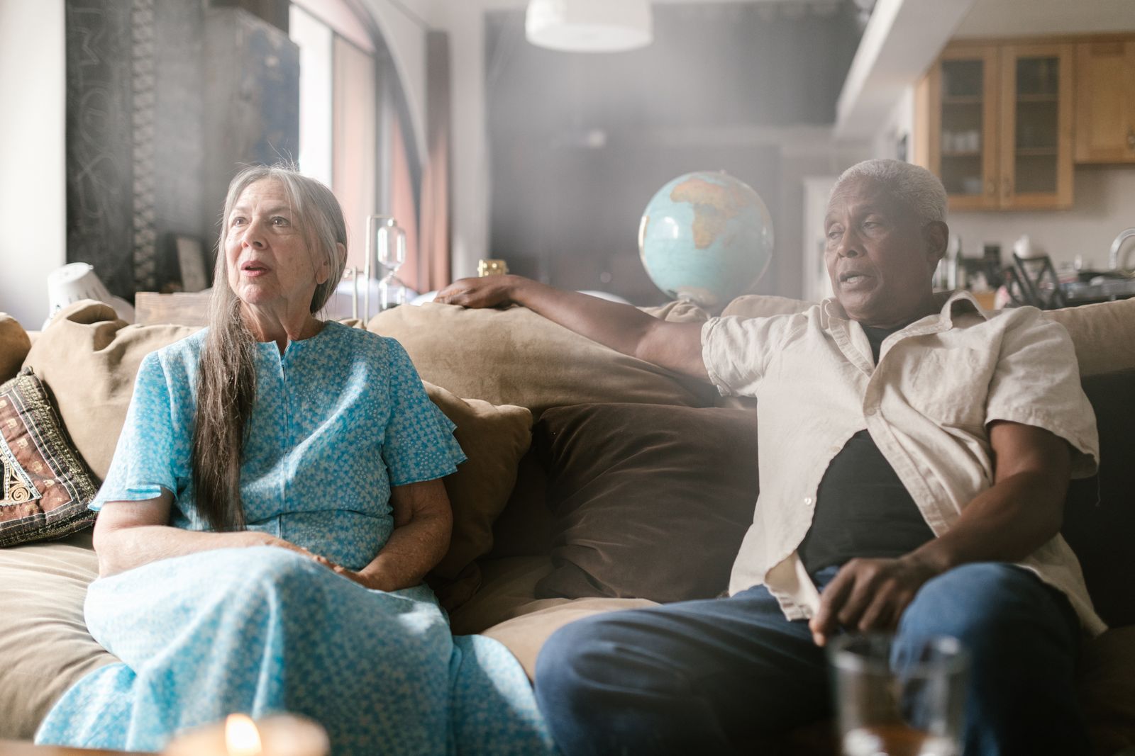 Senior couple sitting together on a sofa in their home