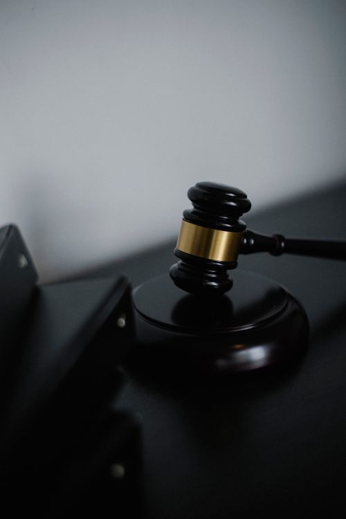 Wooden gavel resting on its sound block