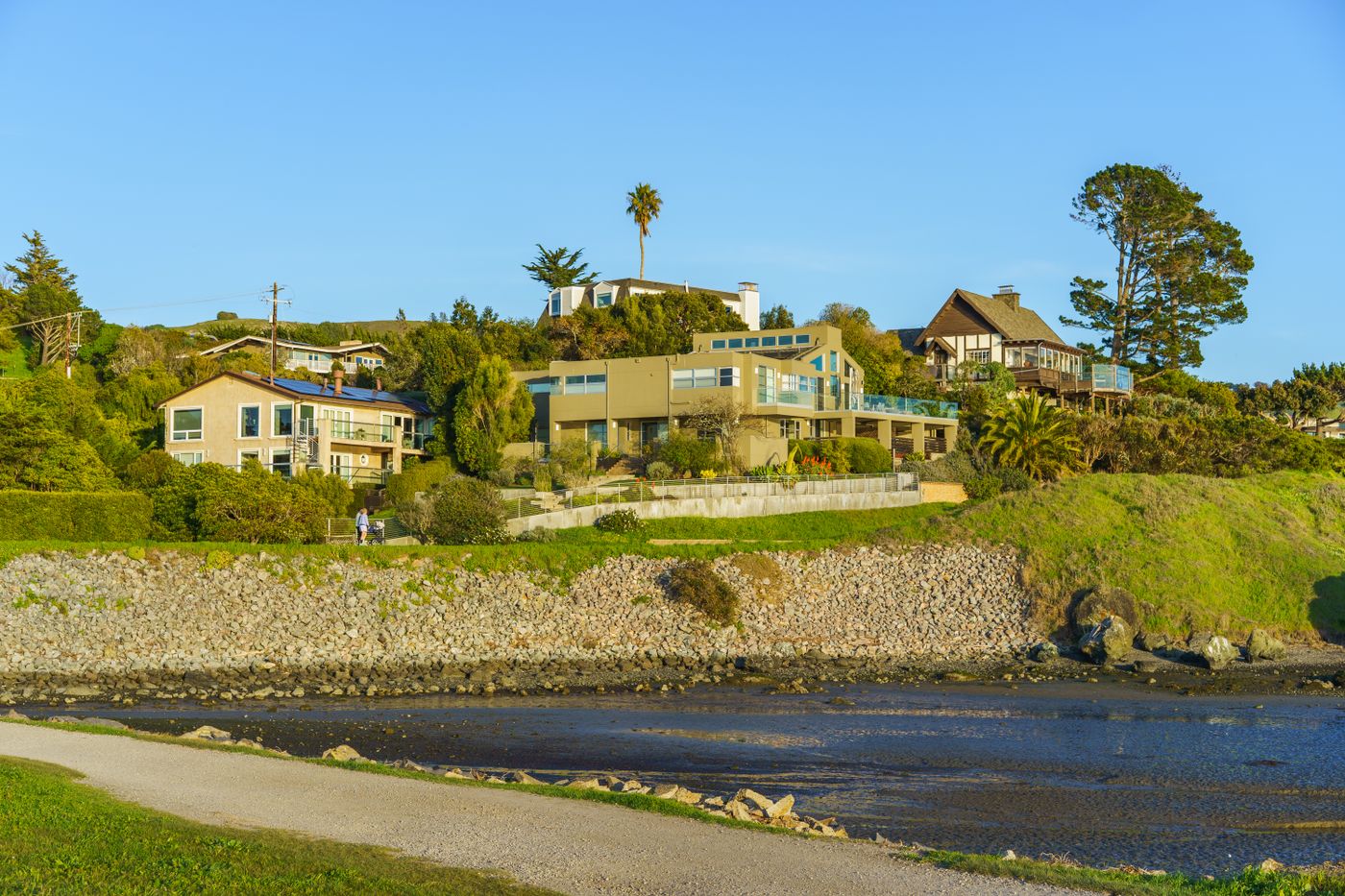 Hillside homes overlooking a coastal waterway in California on a sunny day